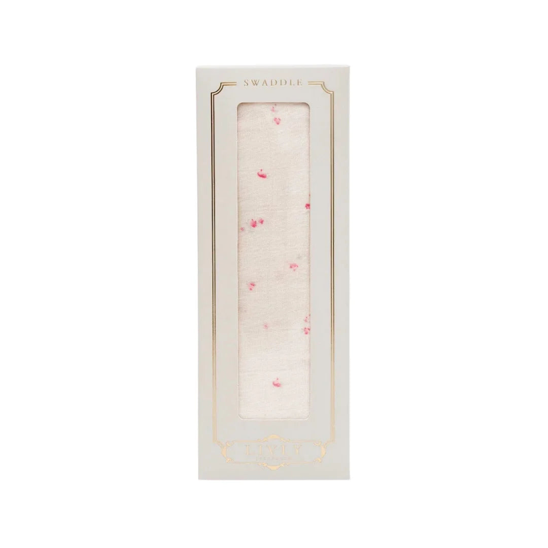 A front view of the Livly Rose Garden swaddle in Ivory.