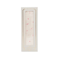 A front view of the Livly Rose Garden swaddle in Ivory.