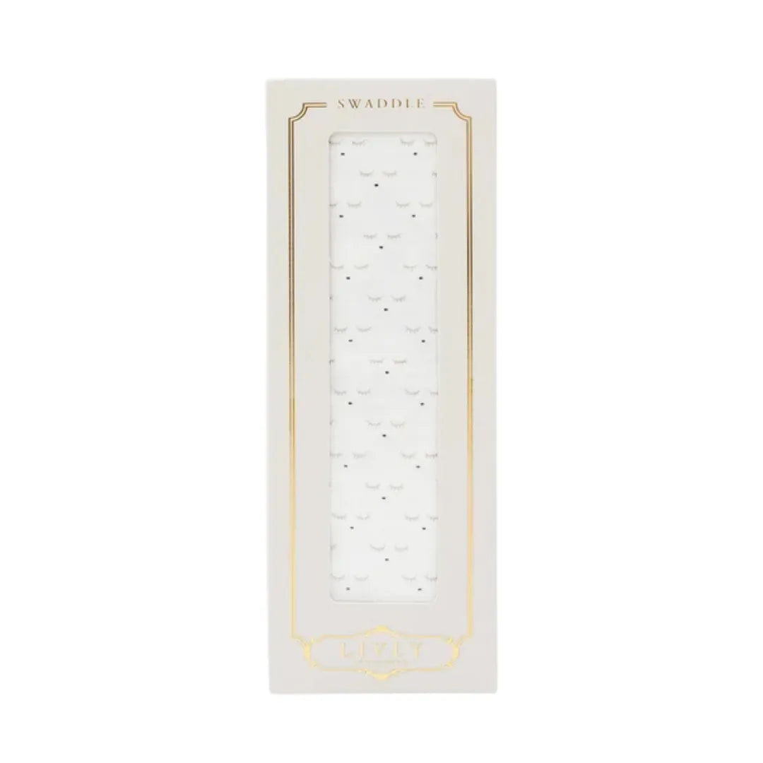 A flat-lay view of the Livly Sleeping Cutie swaddle blanket in white.