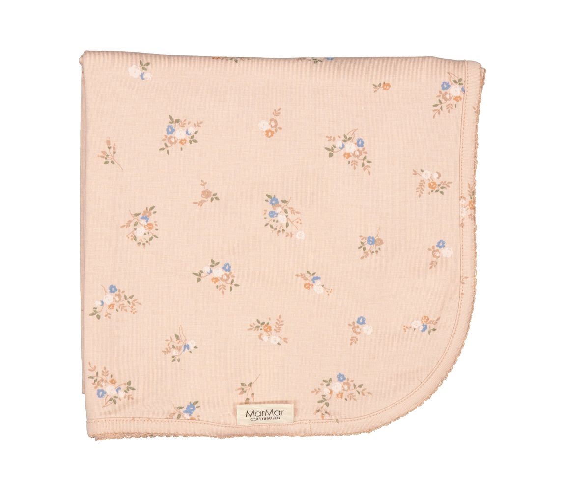 A flat-lay view of the MarMar Copenhagen rose bouquet alida knitted baby blanket.