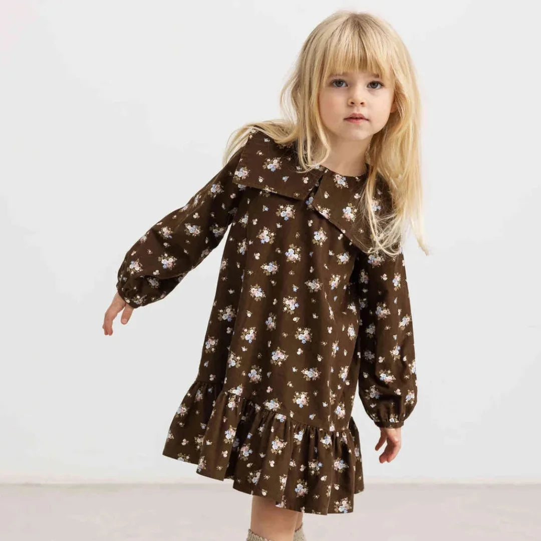 A child wearing the MarMar Copenhagen autumn floral dress comfortably 