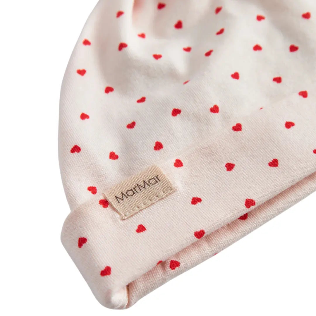 Baby hat with red heart pattern and MarMar label on a white background