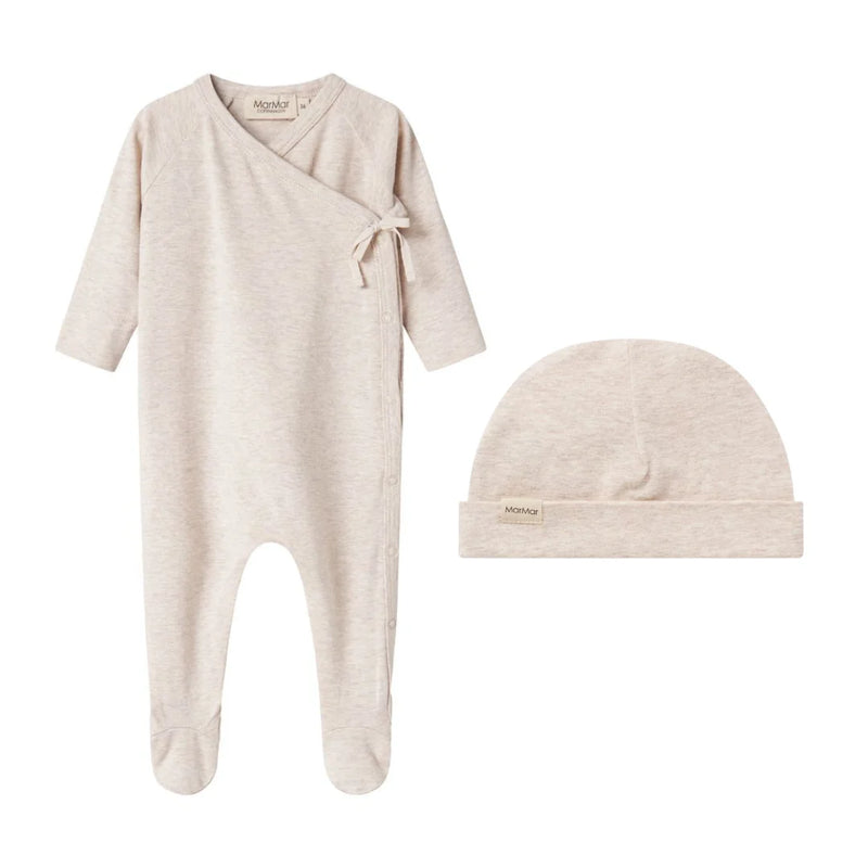 A breathtaking MarMar Copenhagen Light Beige Melange Footie and Hat Set, showcasing its authoritative architectural fit and refined, butter-soft modal texture.