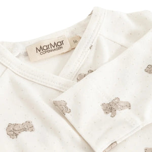 A high-resolution close-up of the organic cotton knit texture and bear motif.