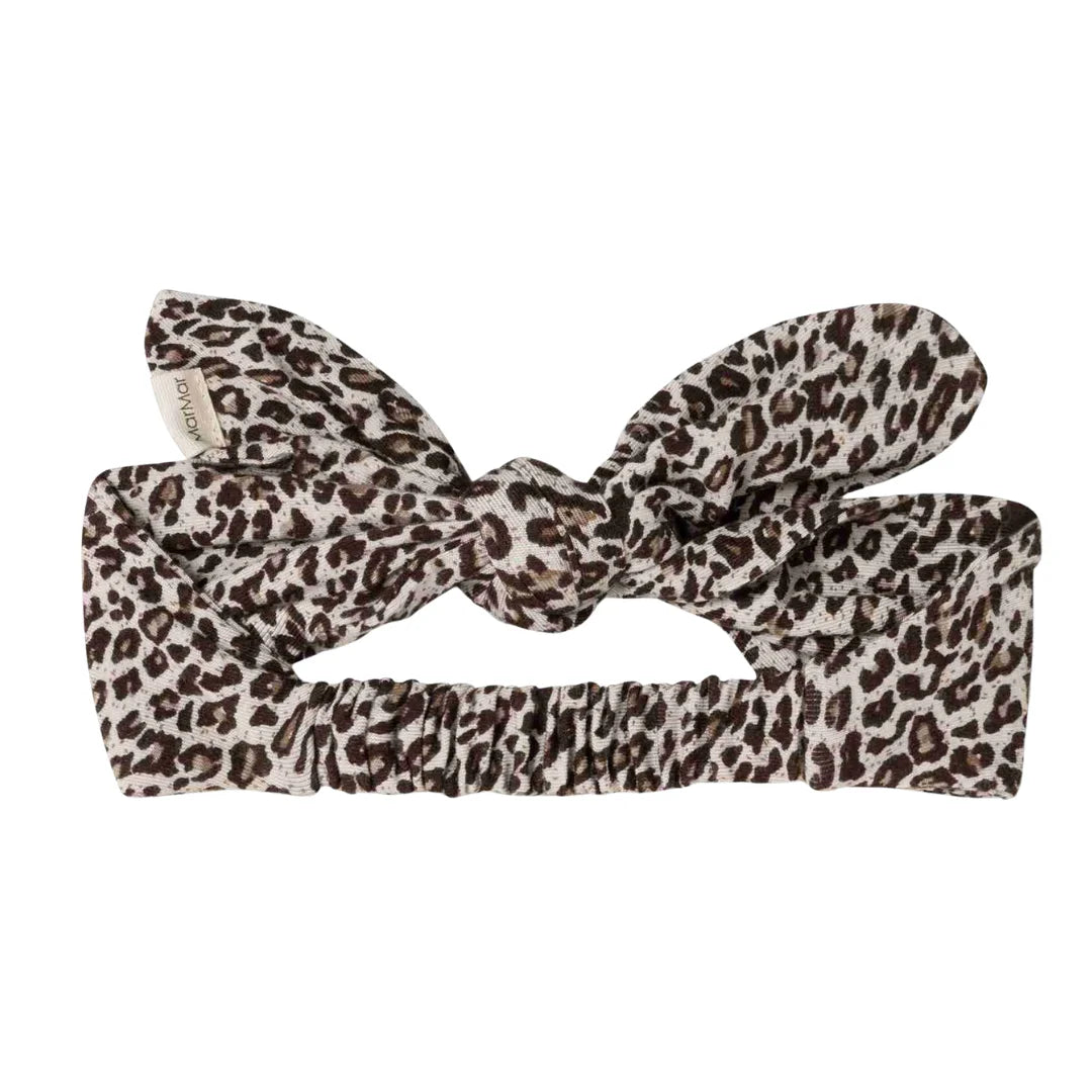 A flat lay display of the MarMar Copenhagen leopard print hair accessory.