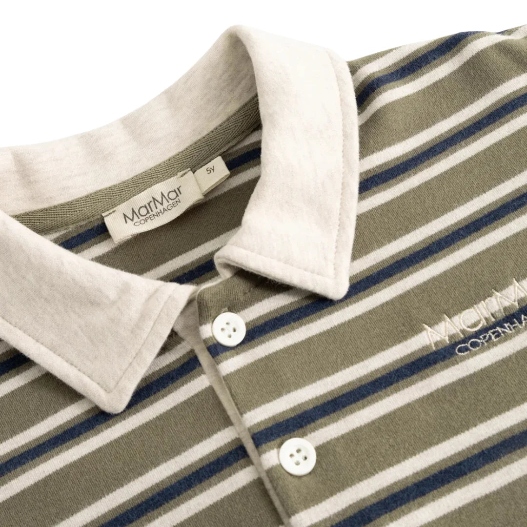 Close-up of a striped polo shirt collar and upper chest. The shirt has an olive green body with white and navy blue horizontal stripes, a contrasting off-white collar, white buttons, and a visible MatMar Copenhagen brand label inside the collar.