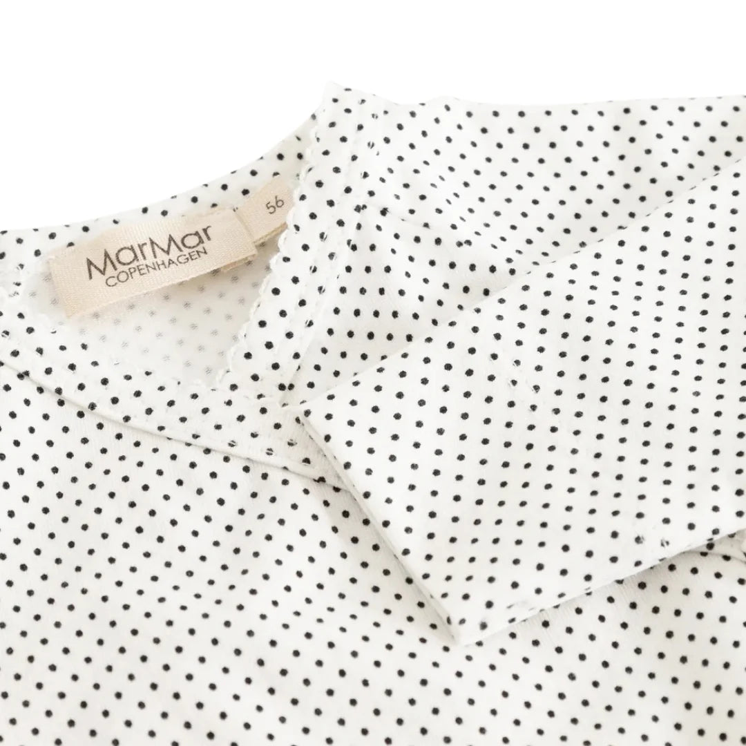A high-resolution close-up of the organic cotton knit texture and dotted pattern.