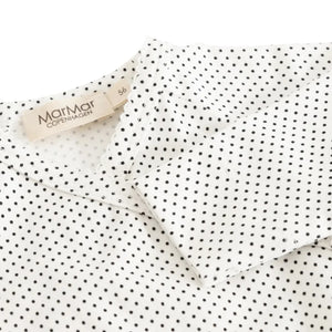 A high-resolution close-up of the organic cotton knit texture and dotted pattern.