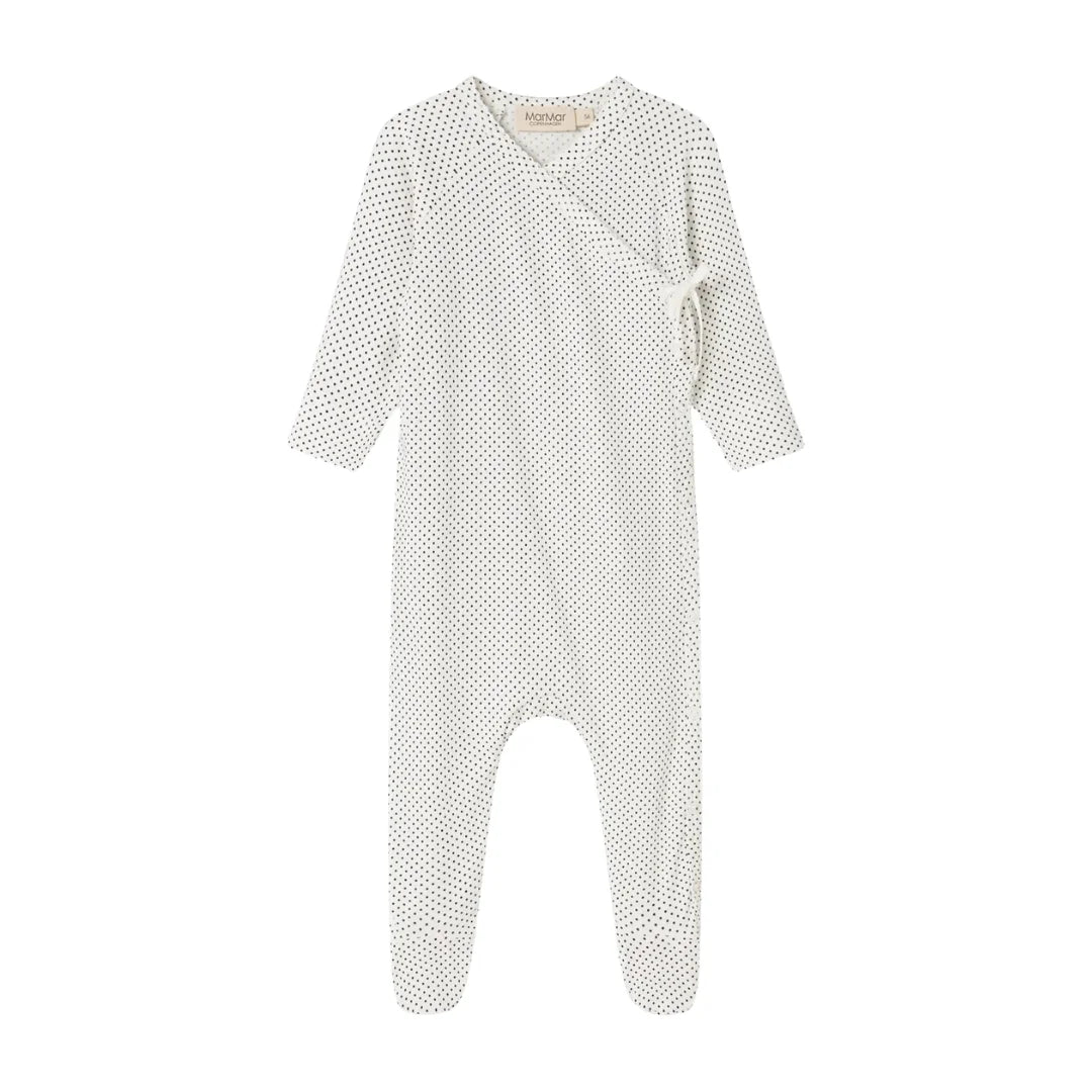 A flat-lay view of the MarMar Copenhagen tiny dots footie in gentle white and neutral.