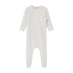 A flat-lay view of the MarMar Copenhagen tiny dots footie in gentle white and neutral.