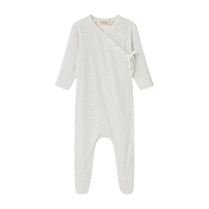A flat-lay view of the MarMar Copenhagen tiny dots footie in gentle white and neutral.