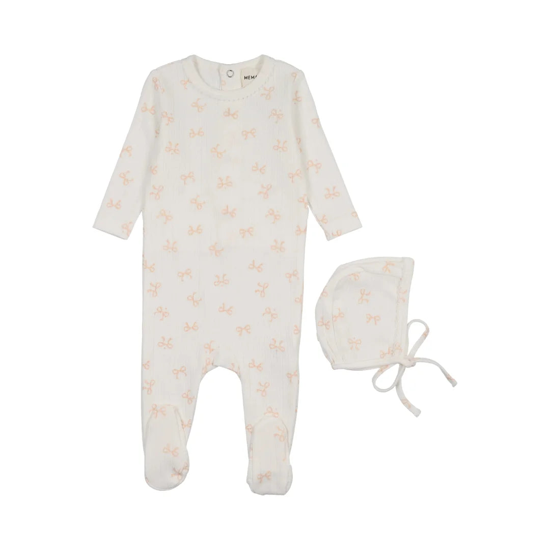 A front view of the Mema Knits bow print pointelle footie and bonnet set in winter white with rose smoke bows.