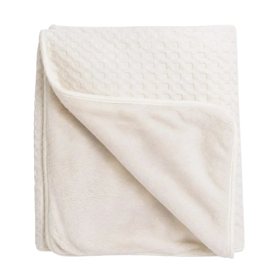 A flat-lay view of the Mema Knits cream waffle fur baby blanket.