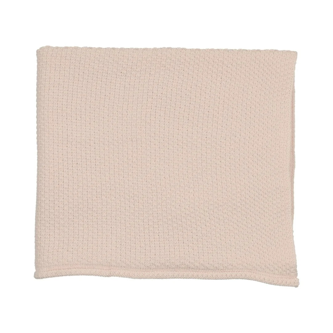 A flat-lay view of the Mema Knits pale pink embroidered edge knit blanket.