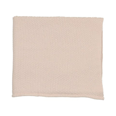 A flat-lay view of the Mema Knits pale pink embroidered edge knit blanket.