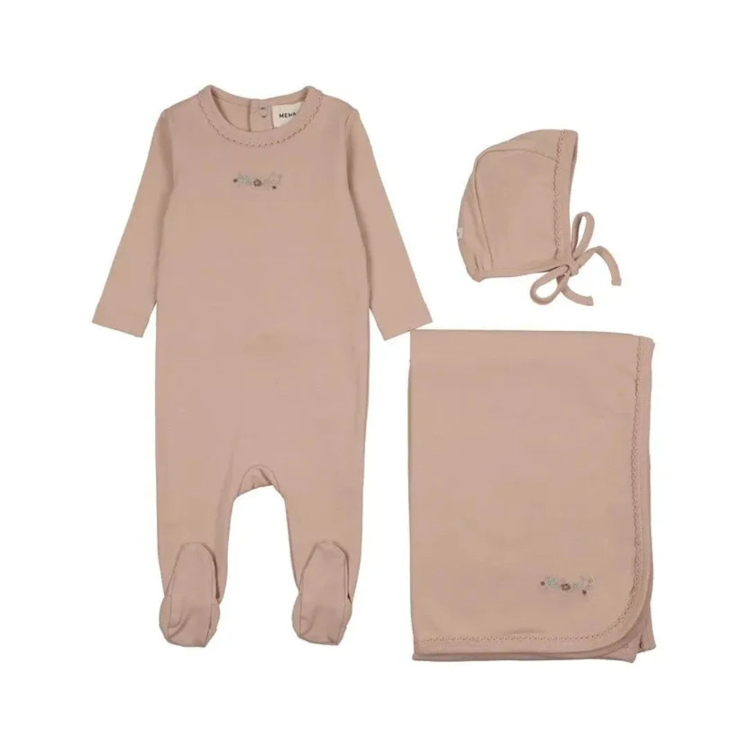 A three-piece baby clothing set in a soft dusty pink color, including a long-sleeve footed romper, a bonnet, and a blanket, all laid out on a solid white background.