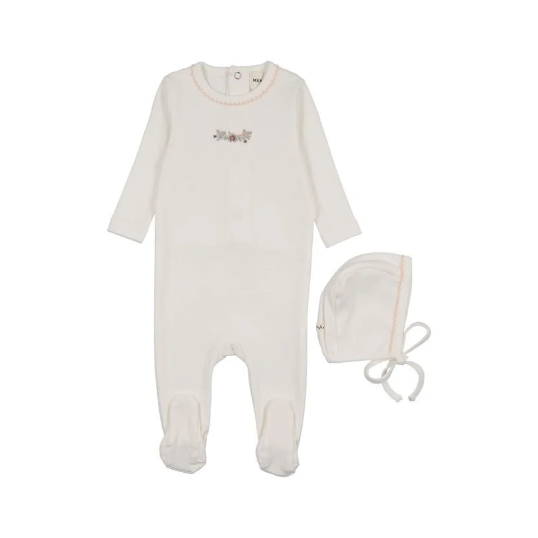 A flat-lay view of the Mema Knits floral white embroidery footie and bonnet set.