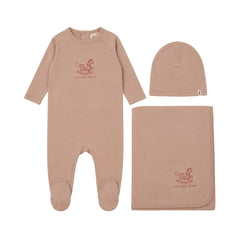 A front view of the Mema Knits pale pink horse rocker three-piece set.