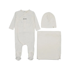 A front view of the Mema Knits mock-wrap polka dot footie three-piece set in white.
