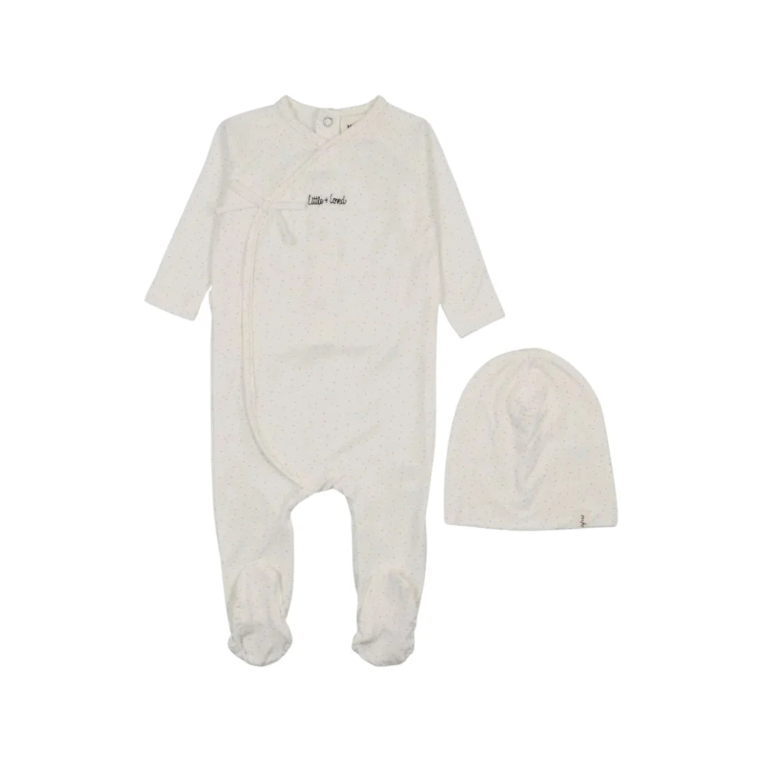 A front view of the Mema Knits mock-wrap polka dot footie and beanie set in white.