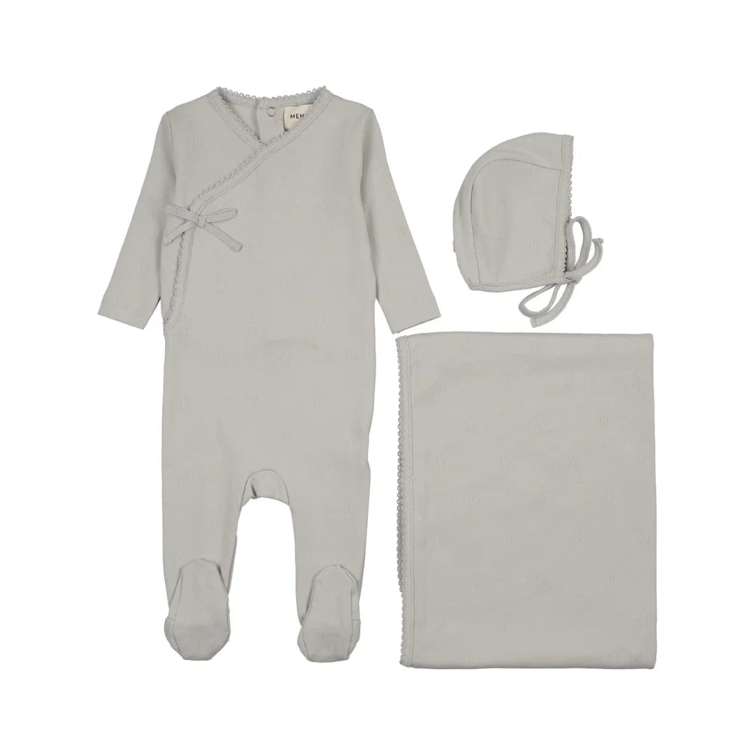 A flat-lay view of the Mema Knits grey dawn pointelle footie 3-piece set.