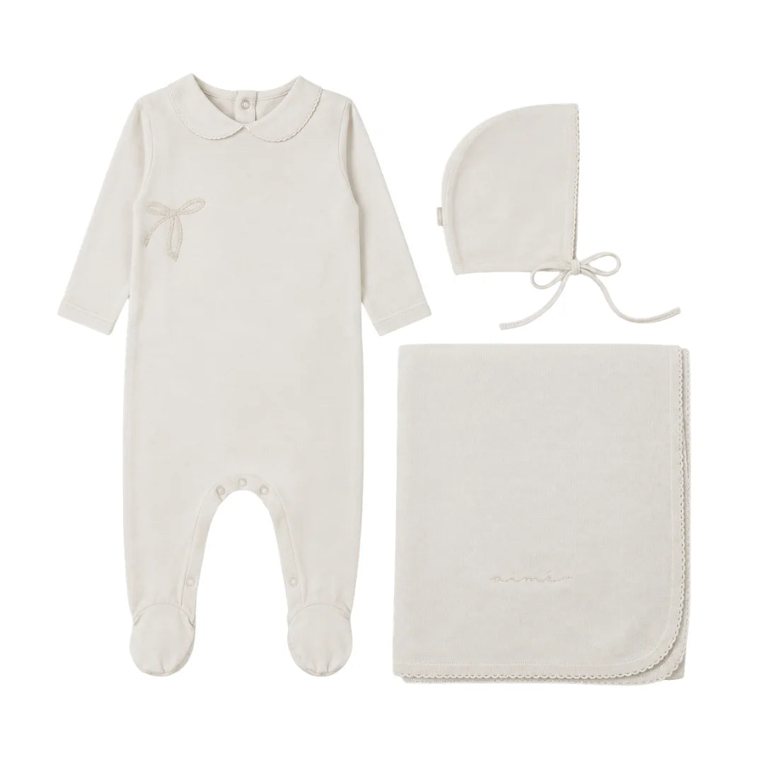 A front view of the Mema Knits pointelle footie three-piece set in ivory.