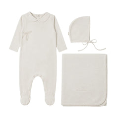 A front view of the Mema Knits pointelle footie three-piece set in ivory.