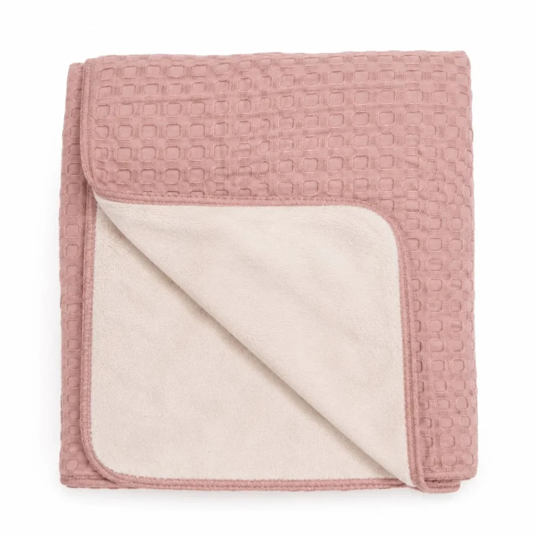 A flat-lay view of the Mema Knits soft pink waffle fur baby blanket.