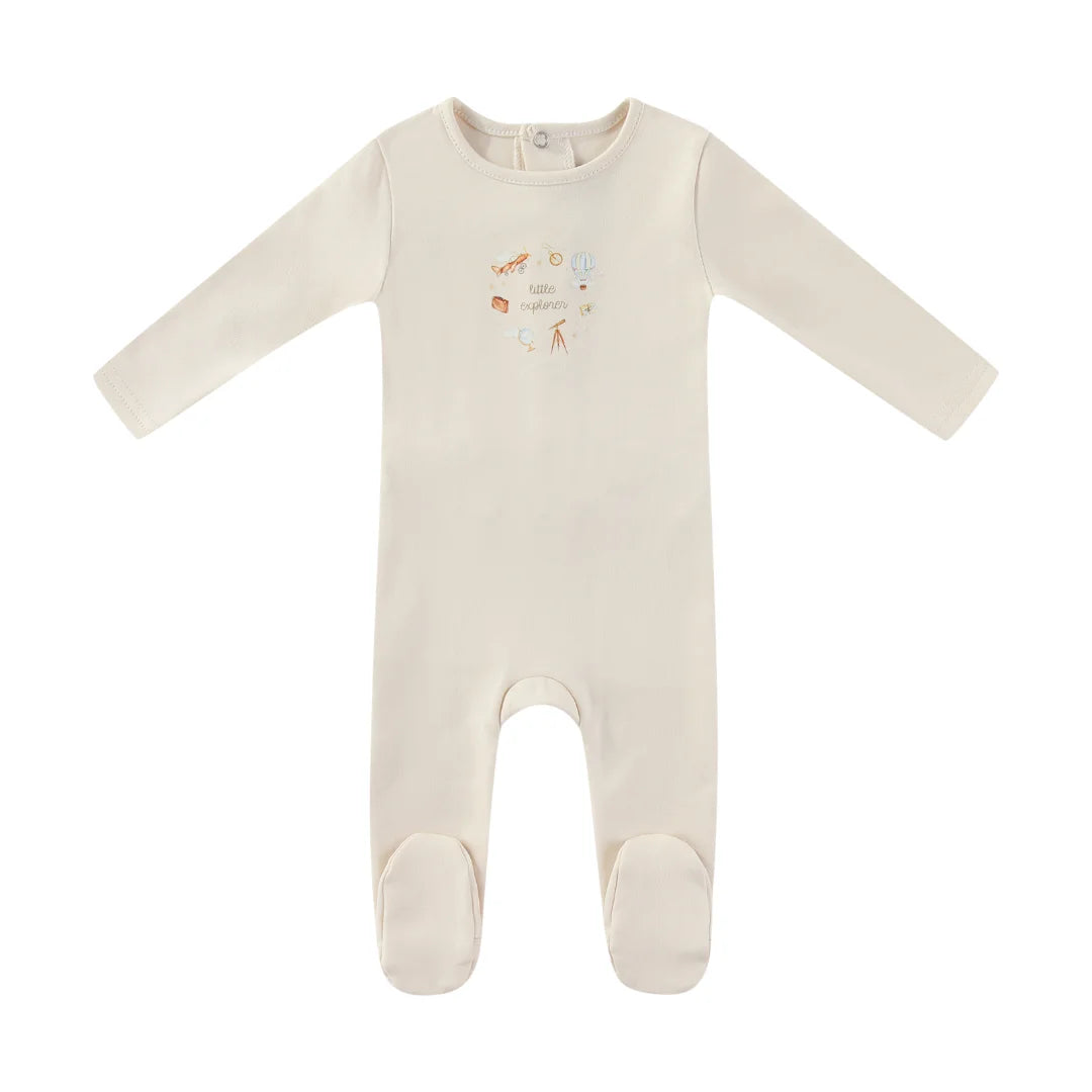 A front view of the Mini Label ivory baby boy footie with a Little Explorer graphic.