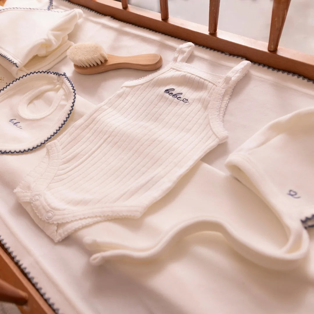 A high-resolution close-up highlighting the soft white velour fabric texture and finishing.