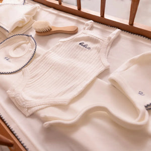 A high-resolution close-up highlighting the soft white velour fabric texture and finishing.