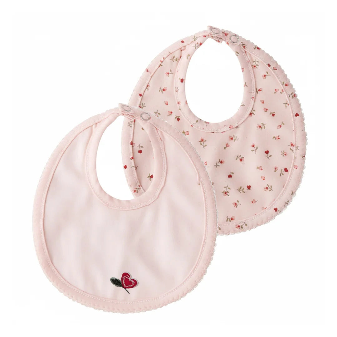 A front view of the Mini Label girls pink heart printed kimono bib.