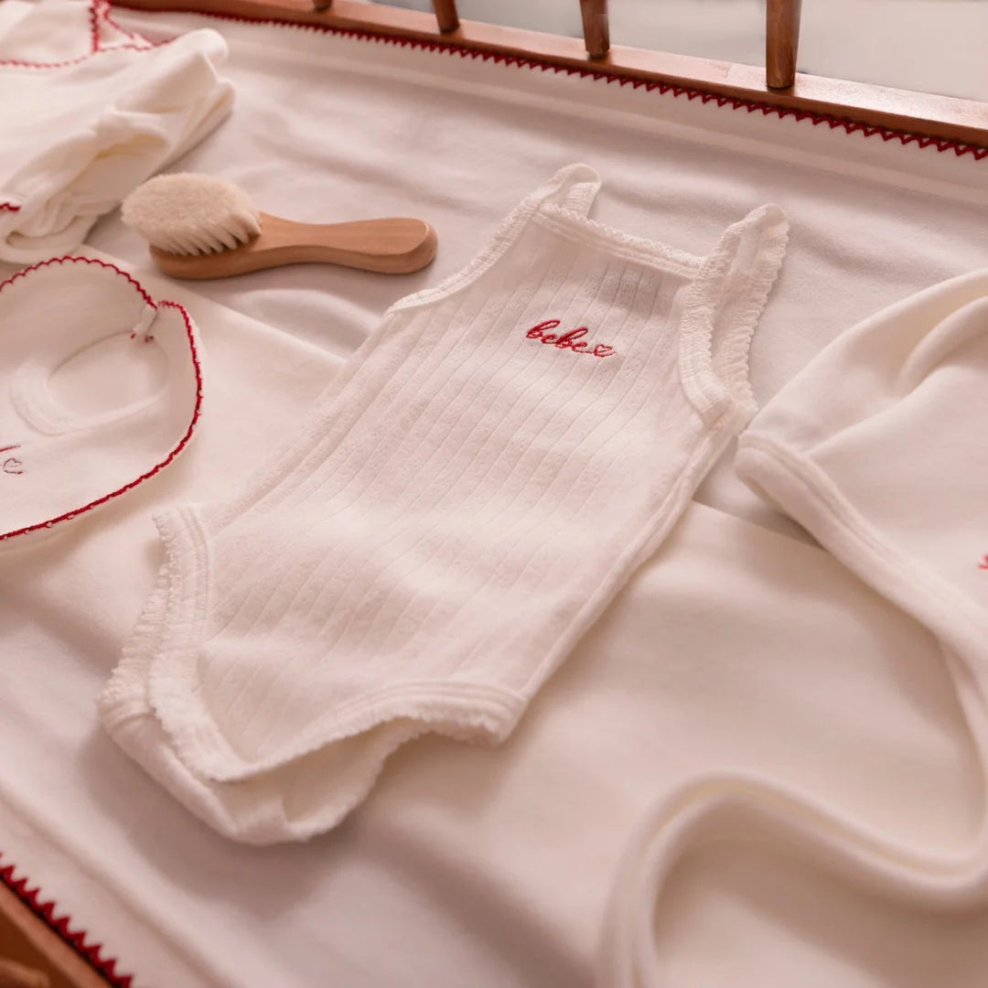 A high-resolution close-up highlighting the soft white velour fabric texture and finishing.