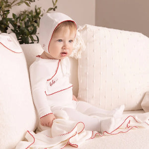An infant styled in the Mini Label white velour gift set during a portrait session.