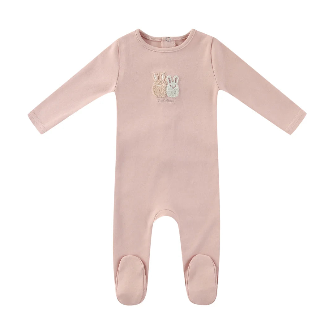 A front view of the Mini Label pink sherpa baby footie with bunny ears.