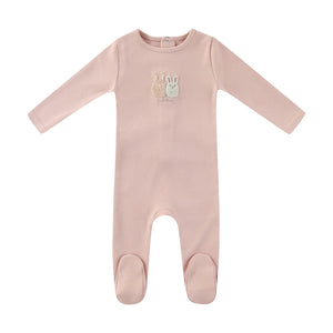 A front view of the Mini Label pink sherpa baby footie with bunny ears.