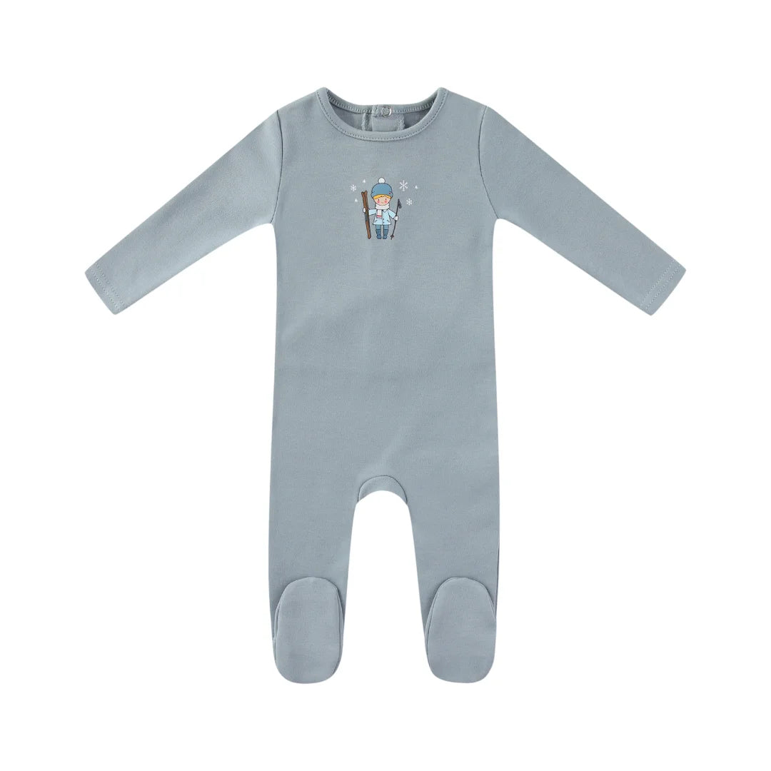 A front view of the Mini Label blue baby footie with a Vintage Skier graphic.