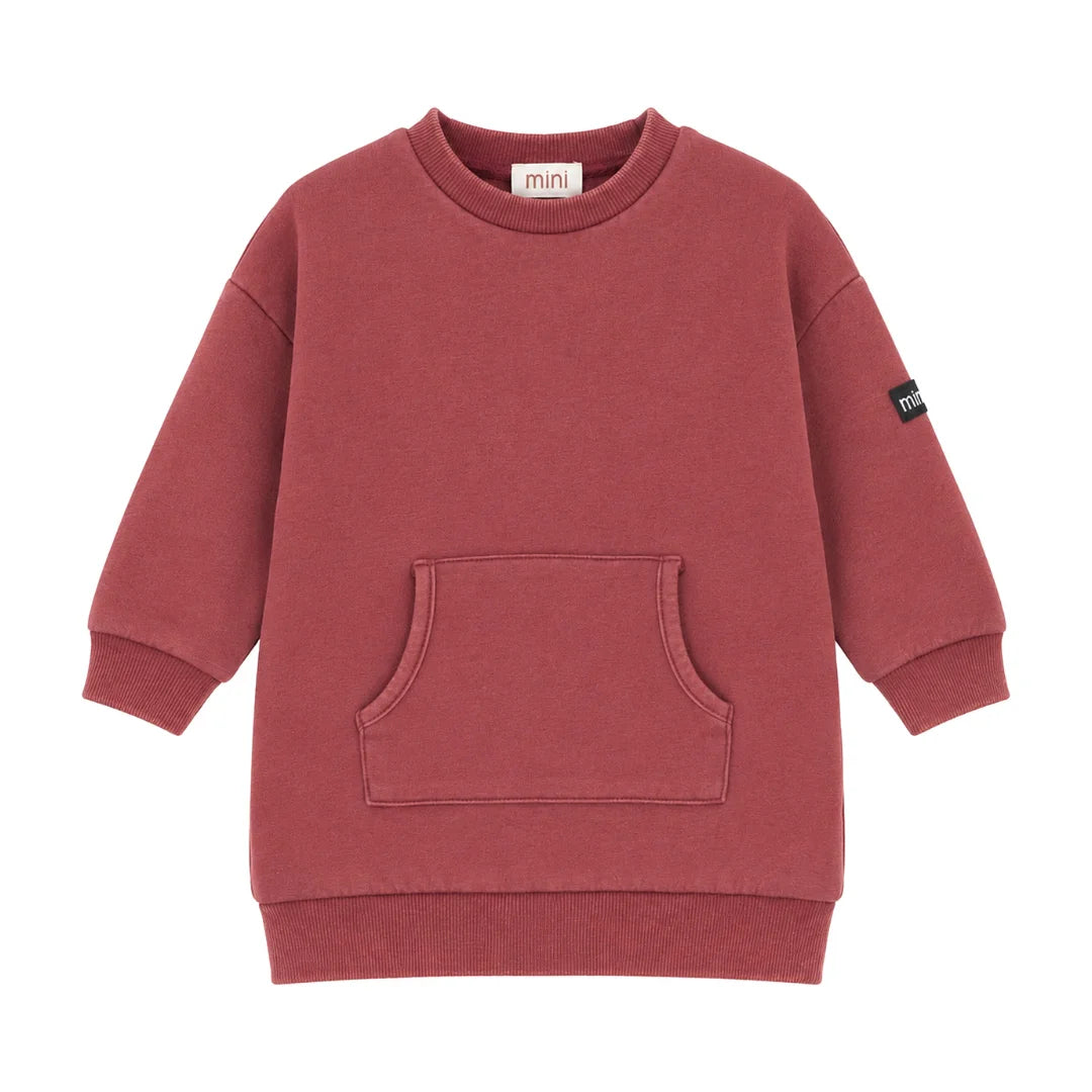 A front view of the Mini P red washed fleece dress with frill pockets.