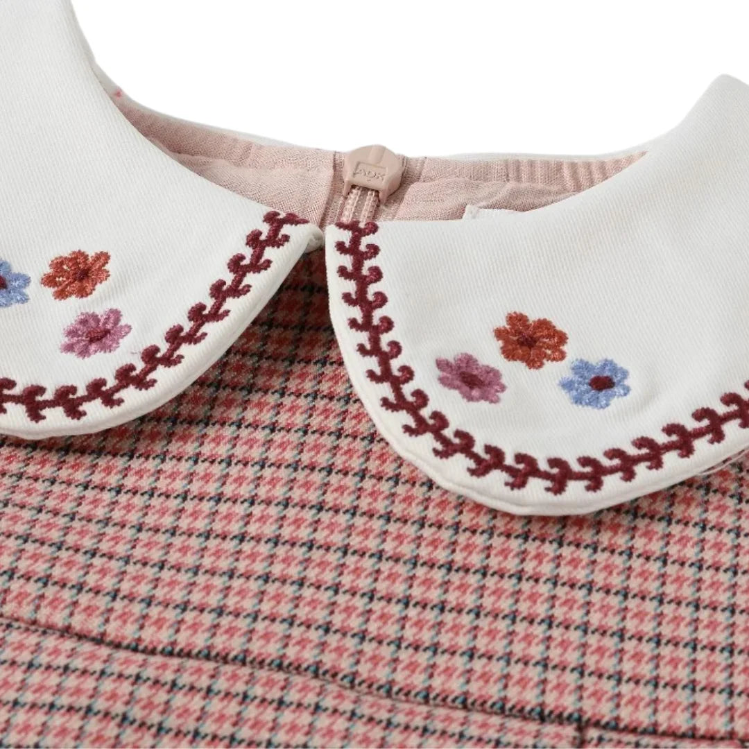 A high-resolution close-up of the houndstooth fabric texture and stitching details.