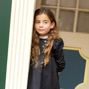A child wearing the Nou Nelle black taffeta dress 