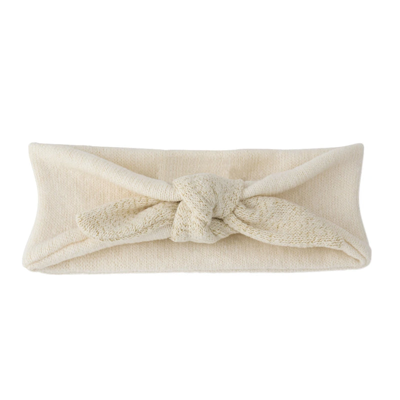 A breathtaking 1+ in the Family Ajaccio Knit Head Wrap in Ecru, showcasing its authoritative architectural knot and refined Spanish knit texture.