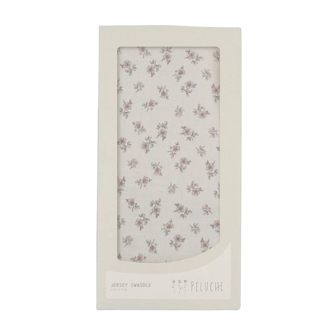 A front view of the Peluche Bebe blossom swaddle blanket in rose.