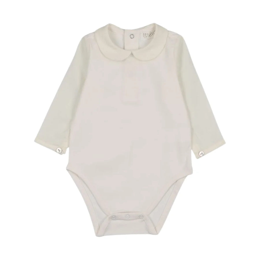 A front view of the Peluche Bebe long sleeve bodysuit with button detailing.