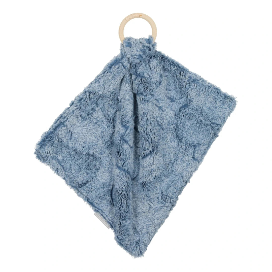 A sophisticated Peluche Bebe Mini Lux Fur Teether in Bluewash Heather, featuring a soft textured blue plush fabric looped through a smooth, architectural wooden ring.