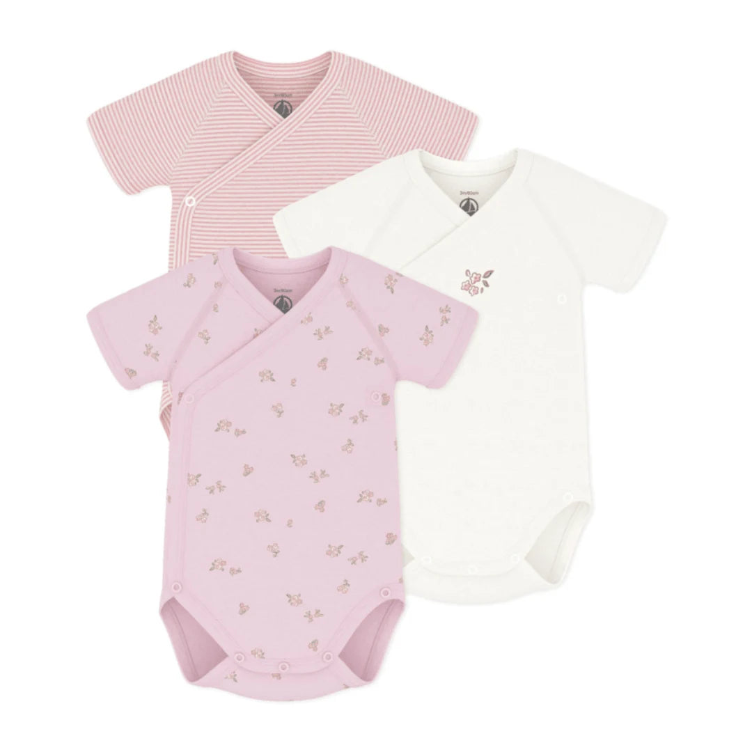 A breathtaking Petit Bateau 3-pack of short sleeve crossover bodysuits featuring an immaculate pink multi palette and seamless snap closures.