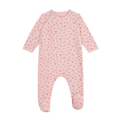 A front view of the Petit Bateau baby girl footie featuring an apple print and side snaps.