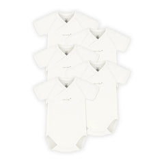 Multiple white baby rompers stacked on a white background
