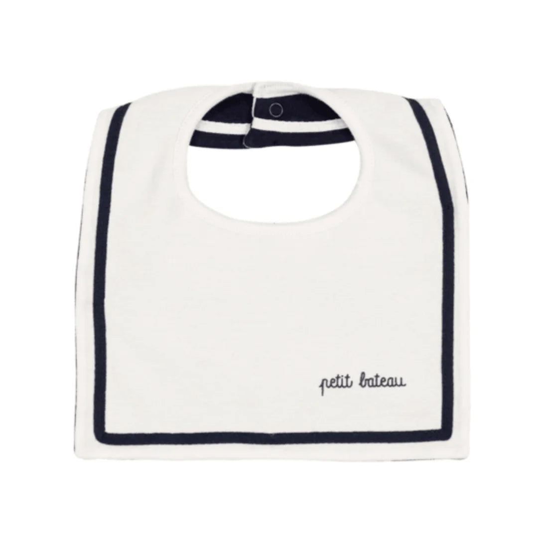 White bib with navy trim and 'petit bateau' branding on a white background