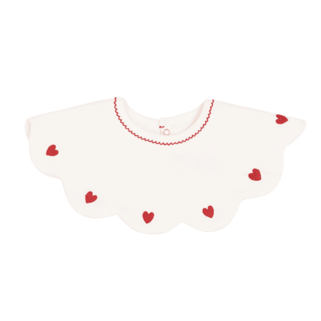 A breathtaking Petit Bateau Baby Bib in pristine white, featuring a delicate heart detail and a secure snap closure.