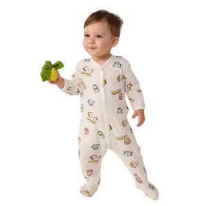 A baby resting comfortably in the Petit Bateau breakfast-print long-sleeve romper.